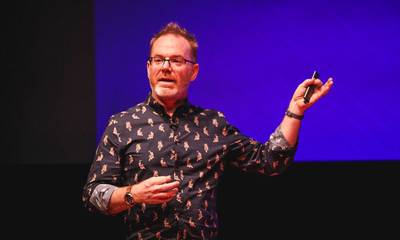 A photo of me during my talk, pointing at the screen
