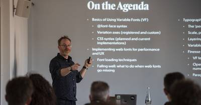 Jason in front of a screen with the workshop agenda showing on it
