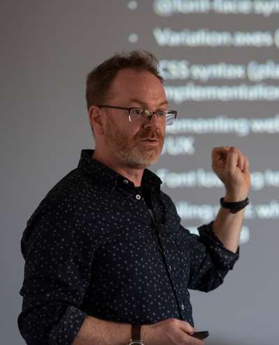 Jason in front of a screen teaching a workshop